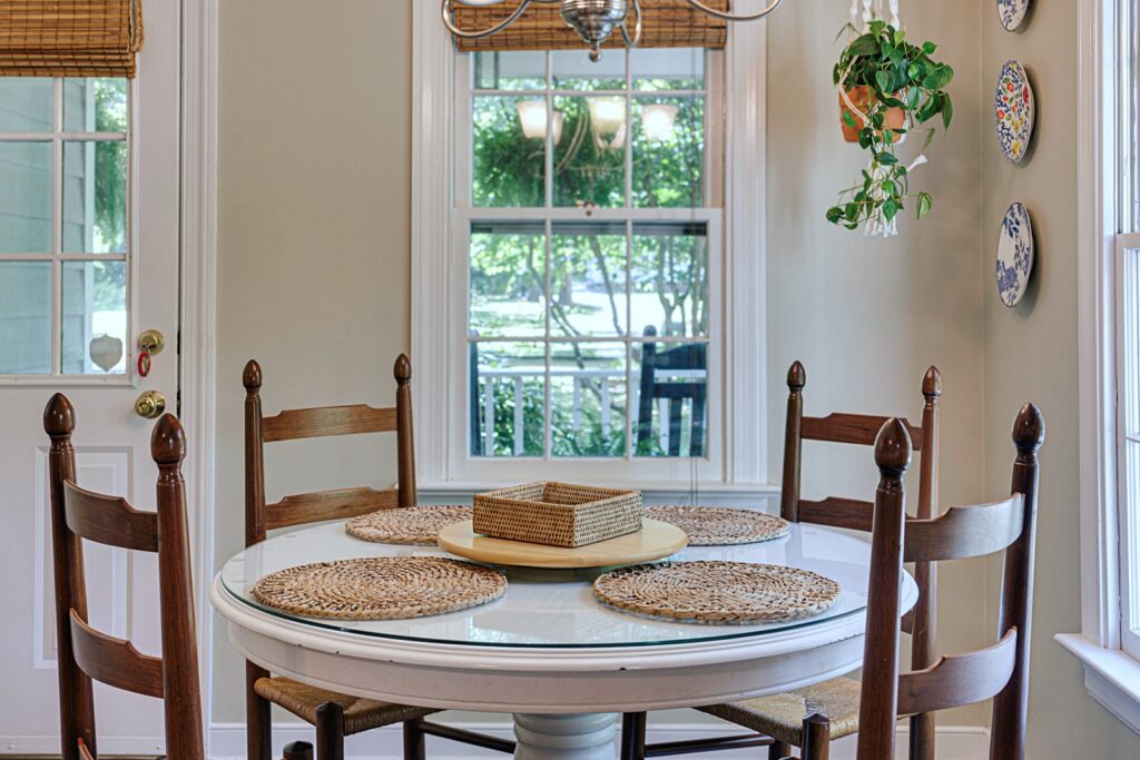 simple creamy white dining room with wood table and chairs
