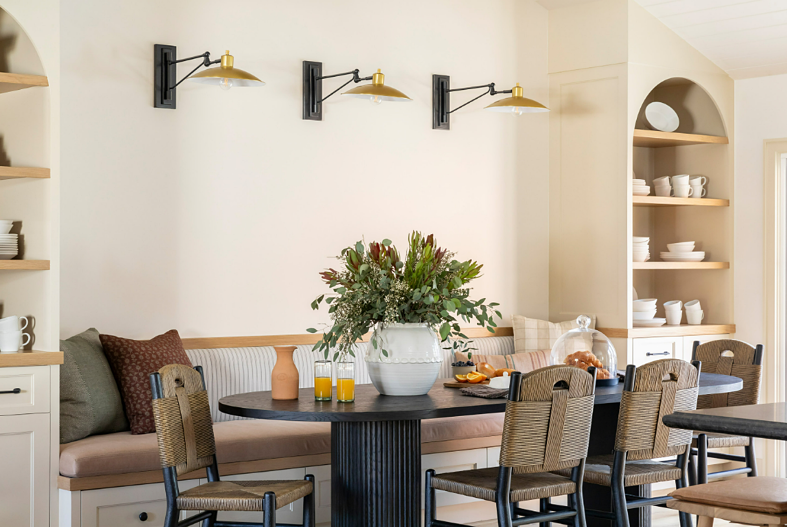 neutral dining room with arched cabinet display