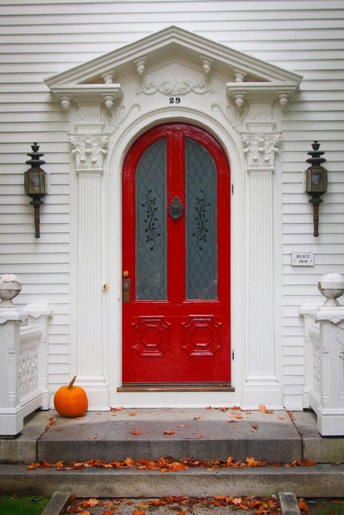 simple front porch with arched red door