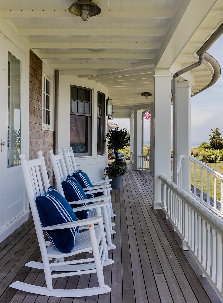 beach style porch with white rocking chairs