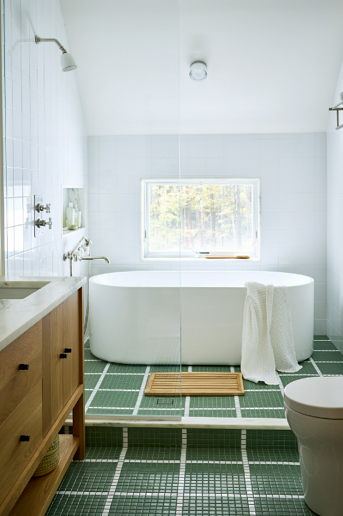spa-like bath with freestanding tub and green tile flooring