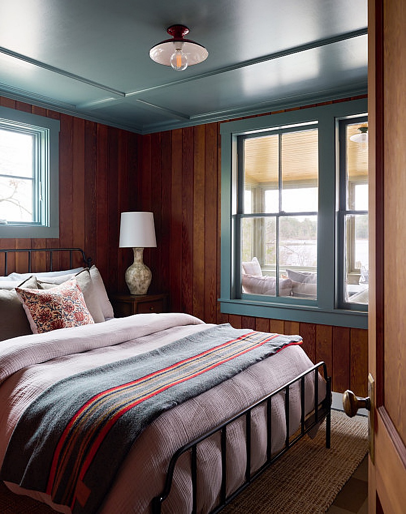 cozy cabin style bedroom with blue ceiling