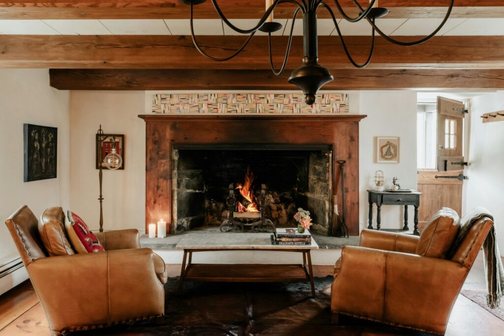 cozy living room with wood fireplace and ceiling beams