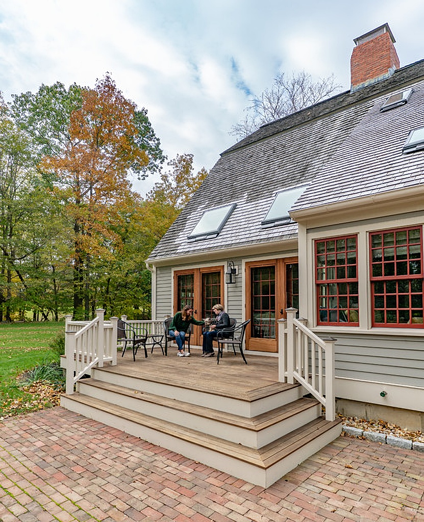 backyard deck leading down to brick patio