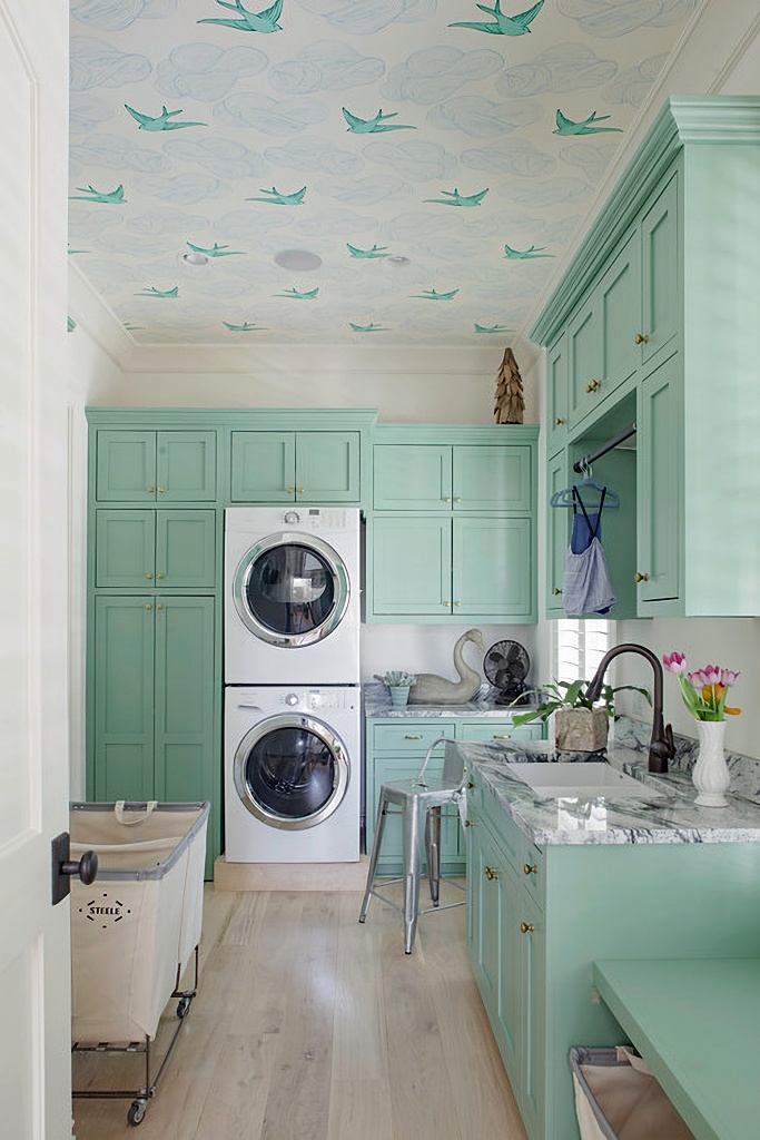 mint green laundry room with wallpapered ceiling