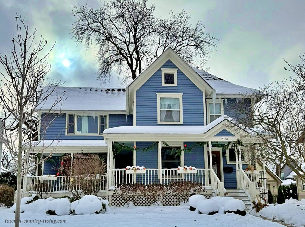 blue farmhouse in snow