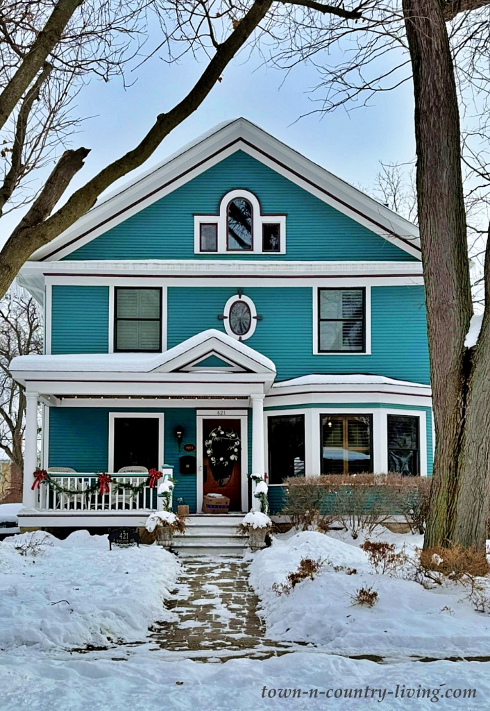teal house in the snow