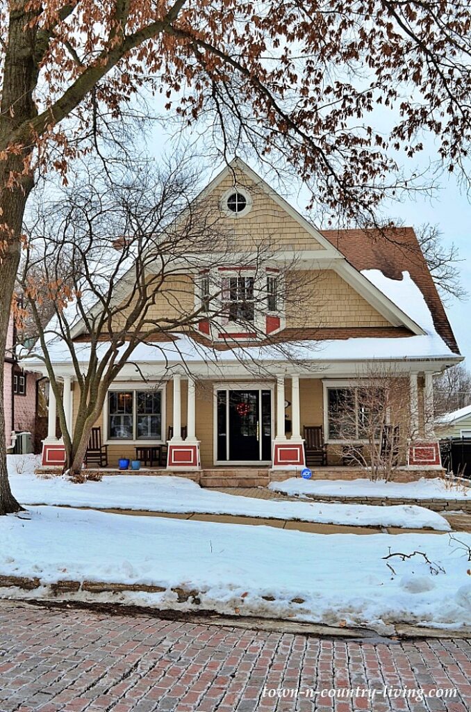 Mustard bungalow home in snow