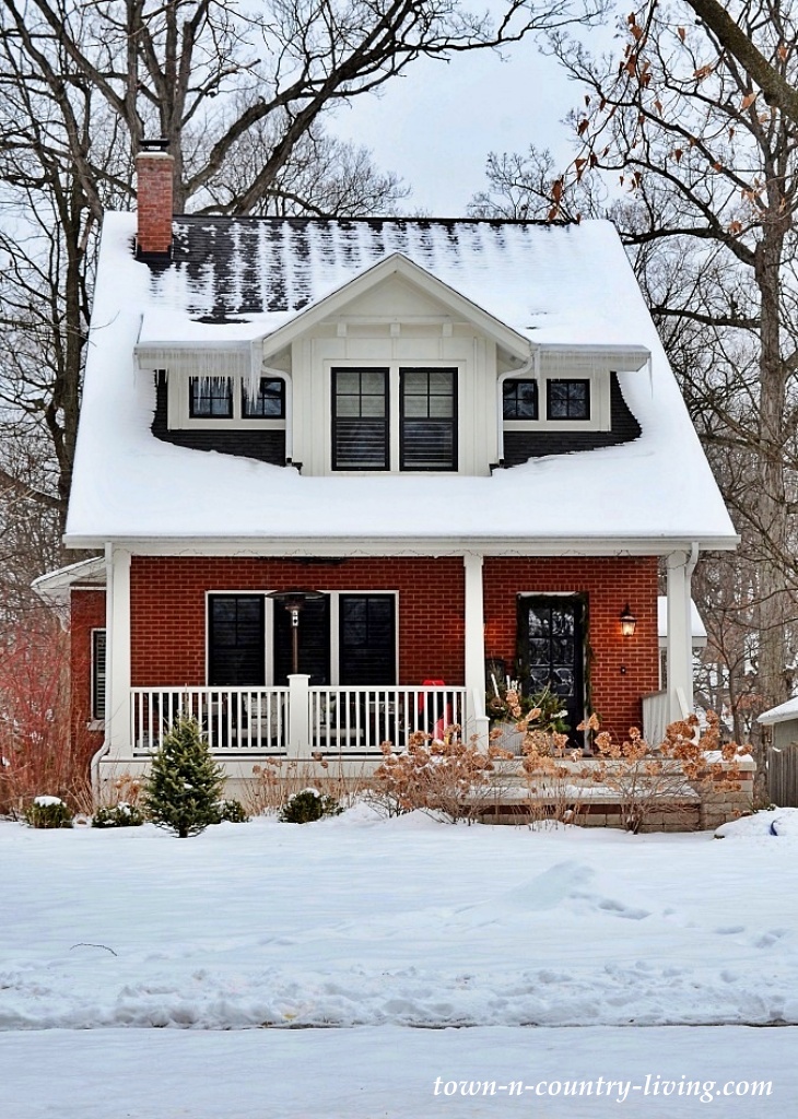 snowy red brick bungalow