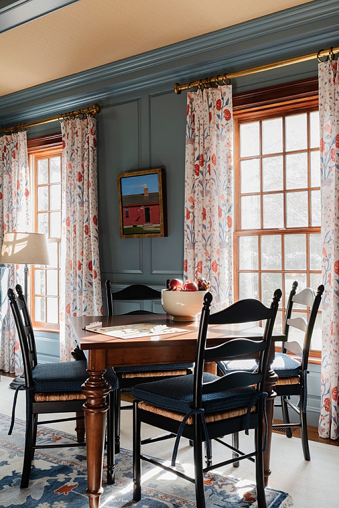 dark blue family room, game table, and floral curtains