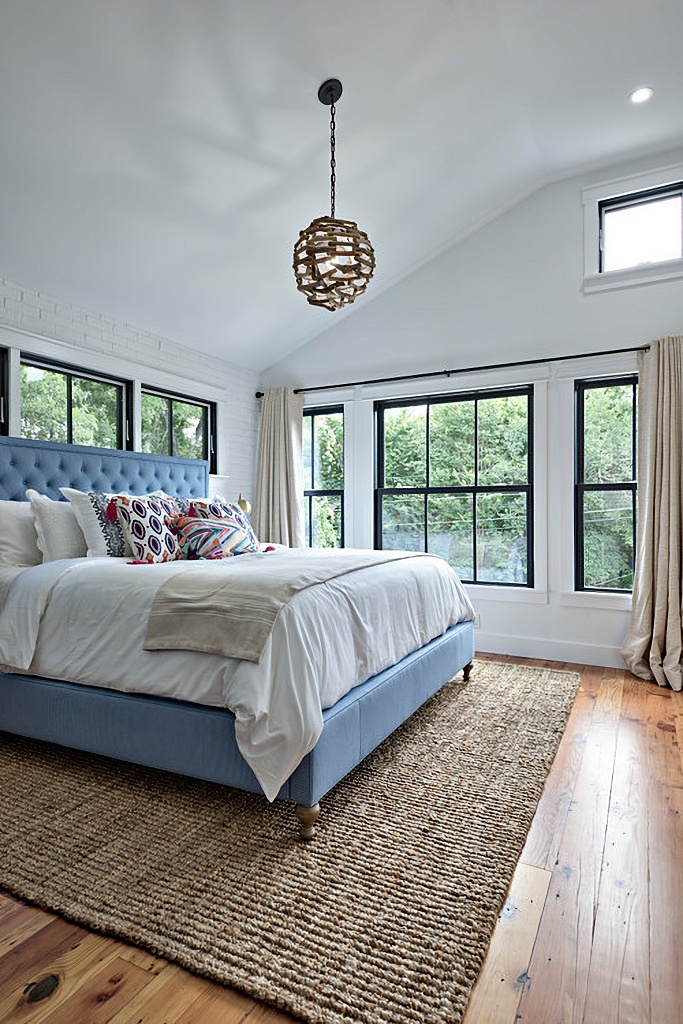 blue and white bedroom with lots of windows