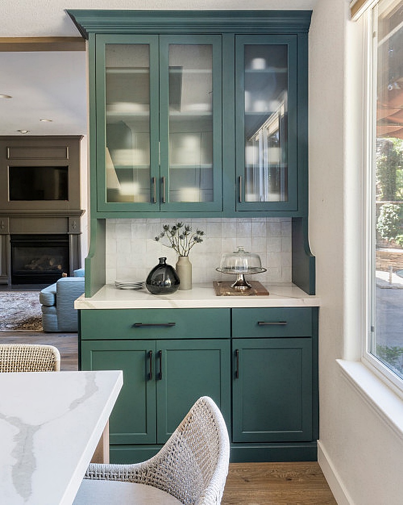 built-in blue-green kitchen cabinet with glass-front doors