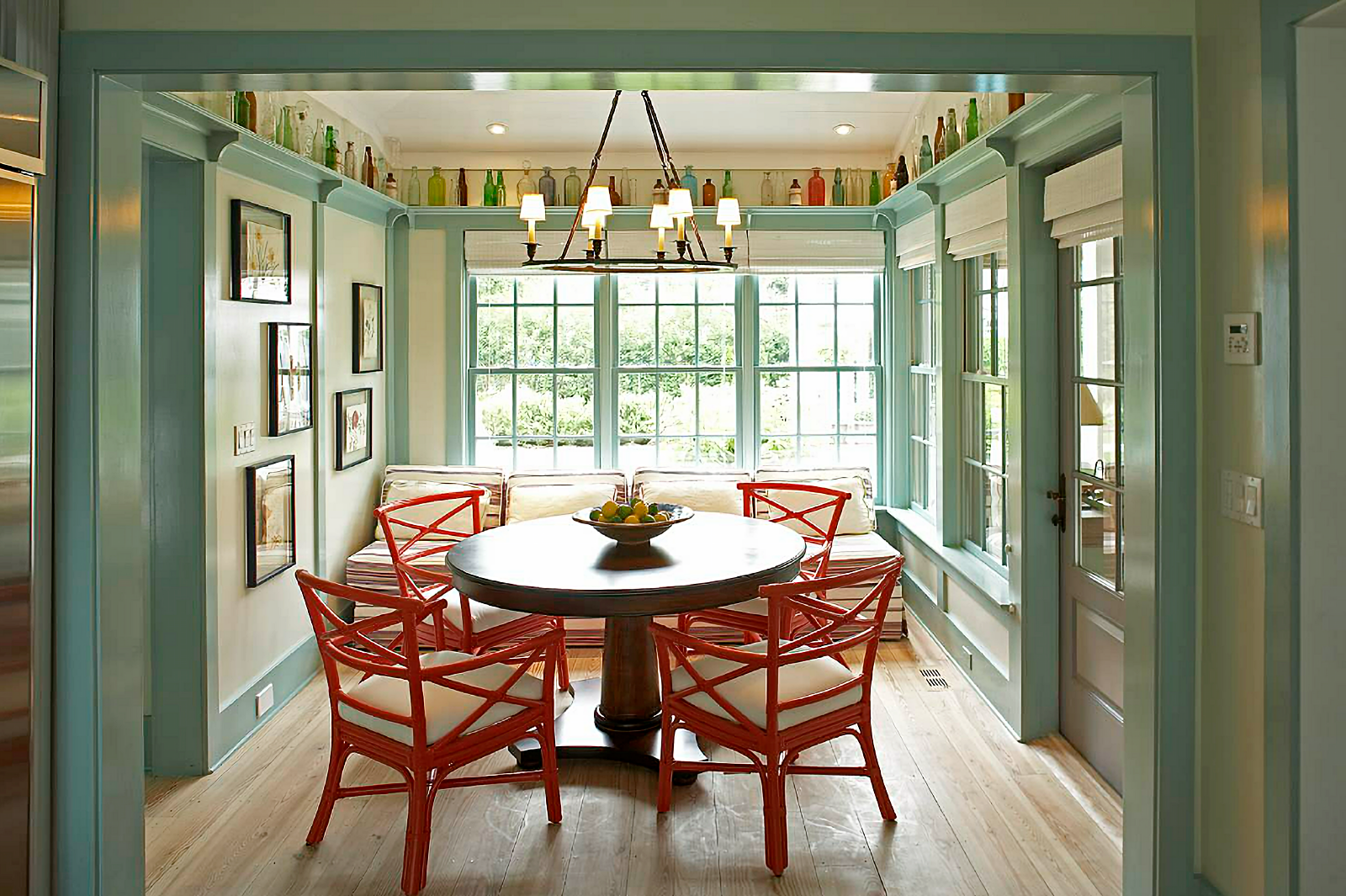 dining room with red chairs and light green trim