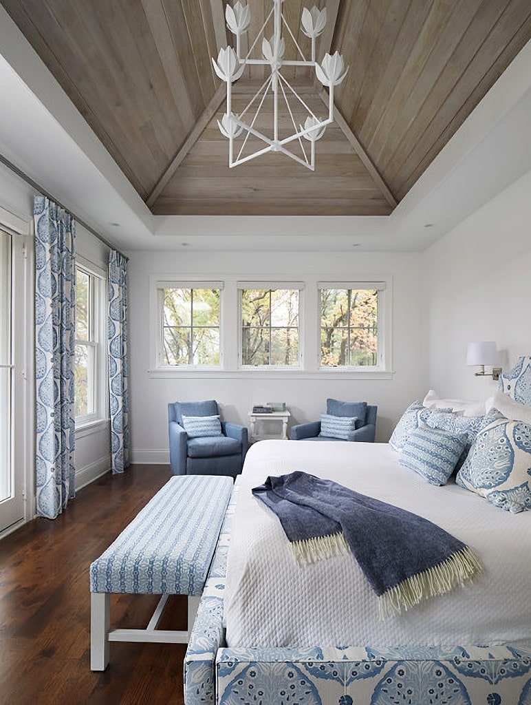 blue and white bedroom with wood vaulted ceiling