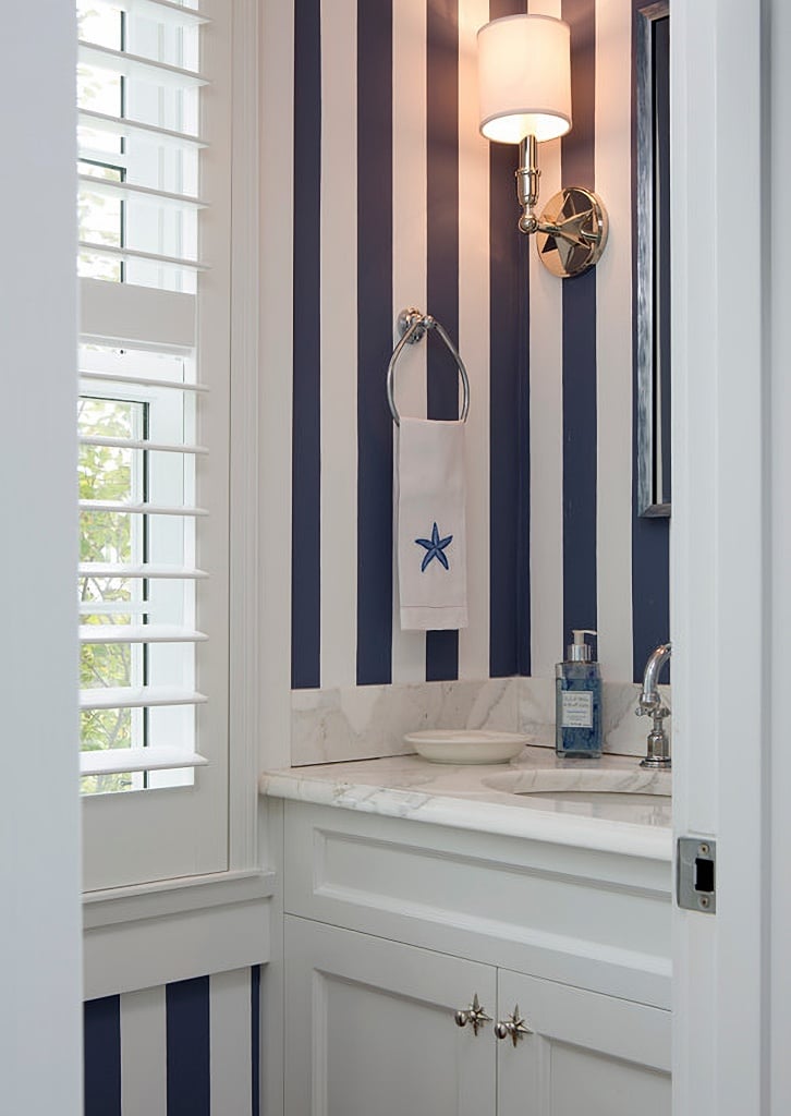 navy and white powder room with playful stripes