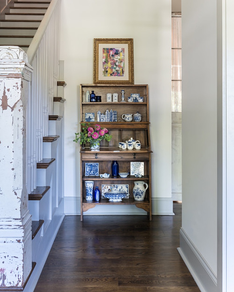 vintage hutch with collectibles in entryway