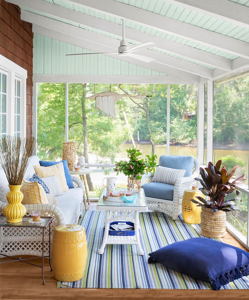 screened porch decorated in blue and yellow