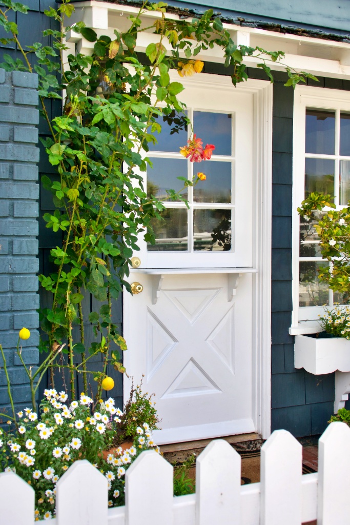 old fashioned beach bungalow with picket fence and garden
