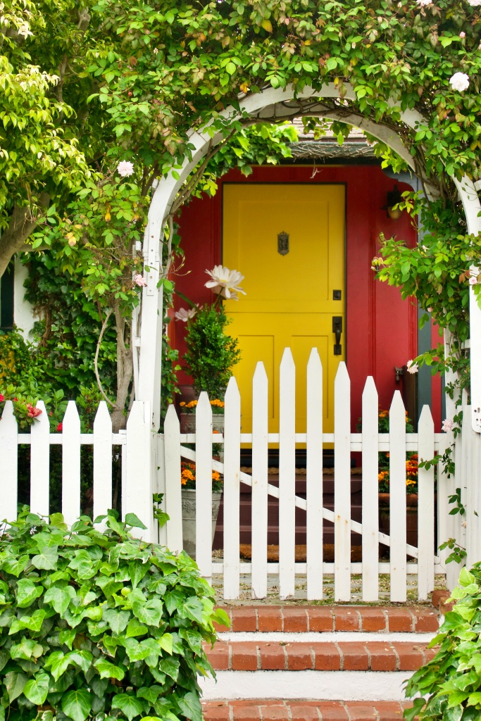 brightly colored beach cottage with lush patio garden