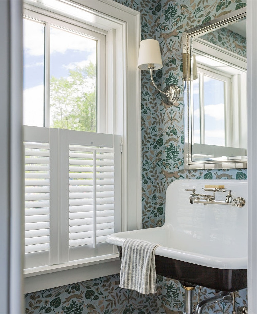 powder room with wallpaper and wall mounted sink