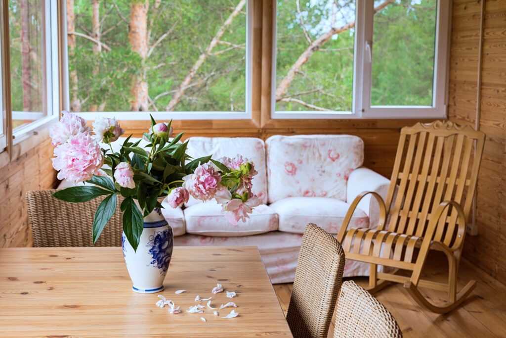 cabin style porch with floral sofa