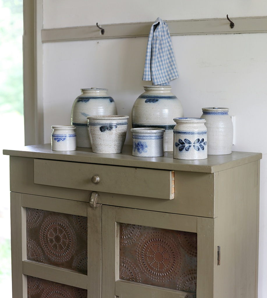 old pie safe with blue and white pottery