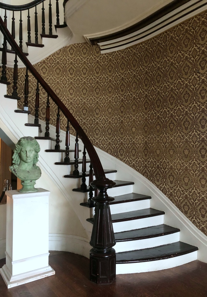 curved staircase with wallpaper