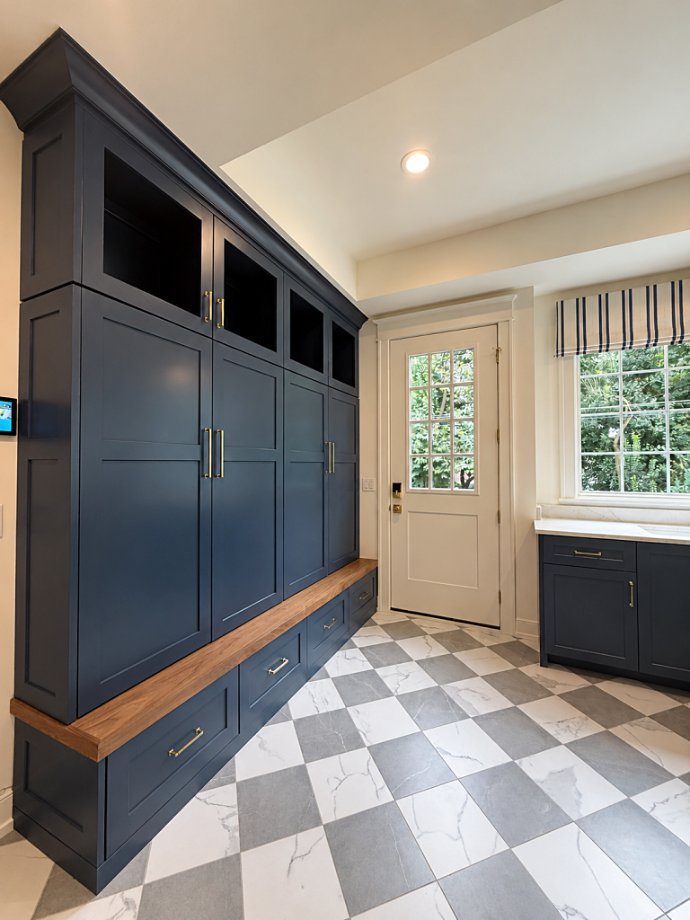 classic mudroom with dark navy cabinets and checkered floor