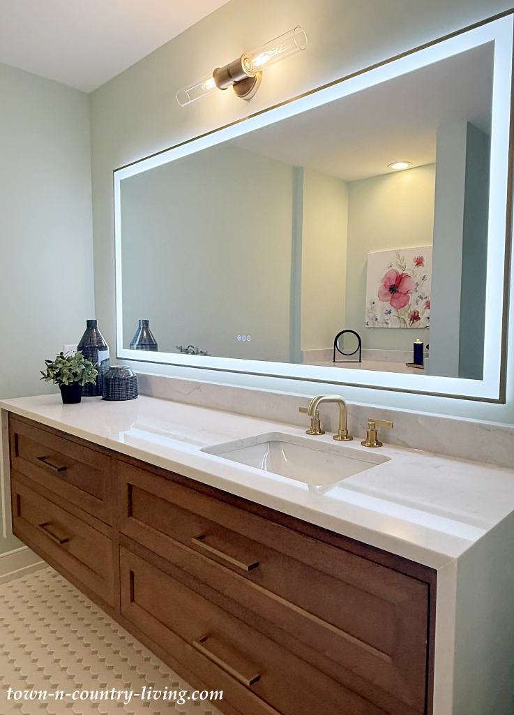 large wood vanity in light blue-green bathroom