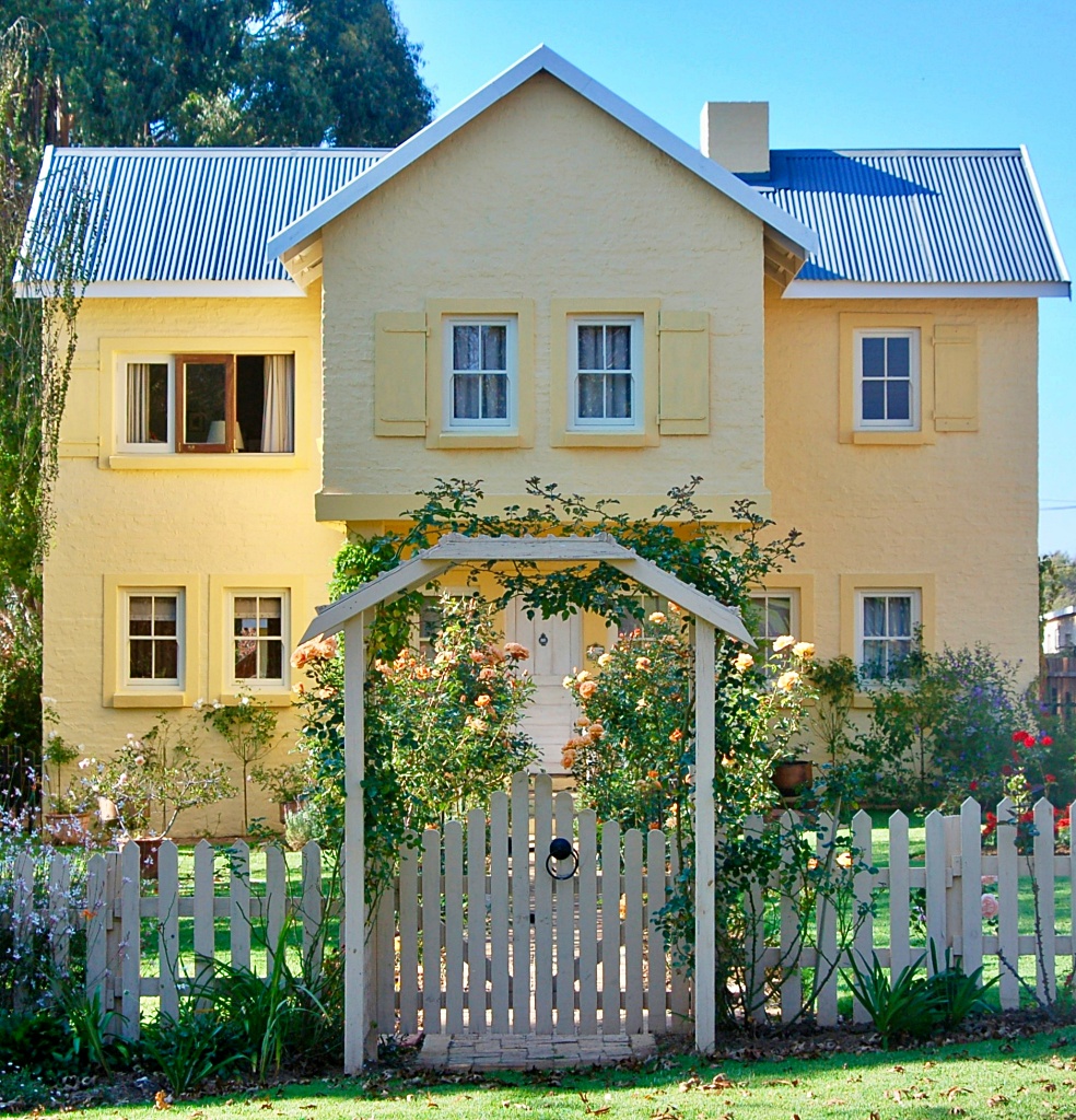 fairy tale style home with arbor