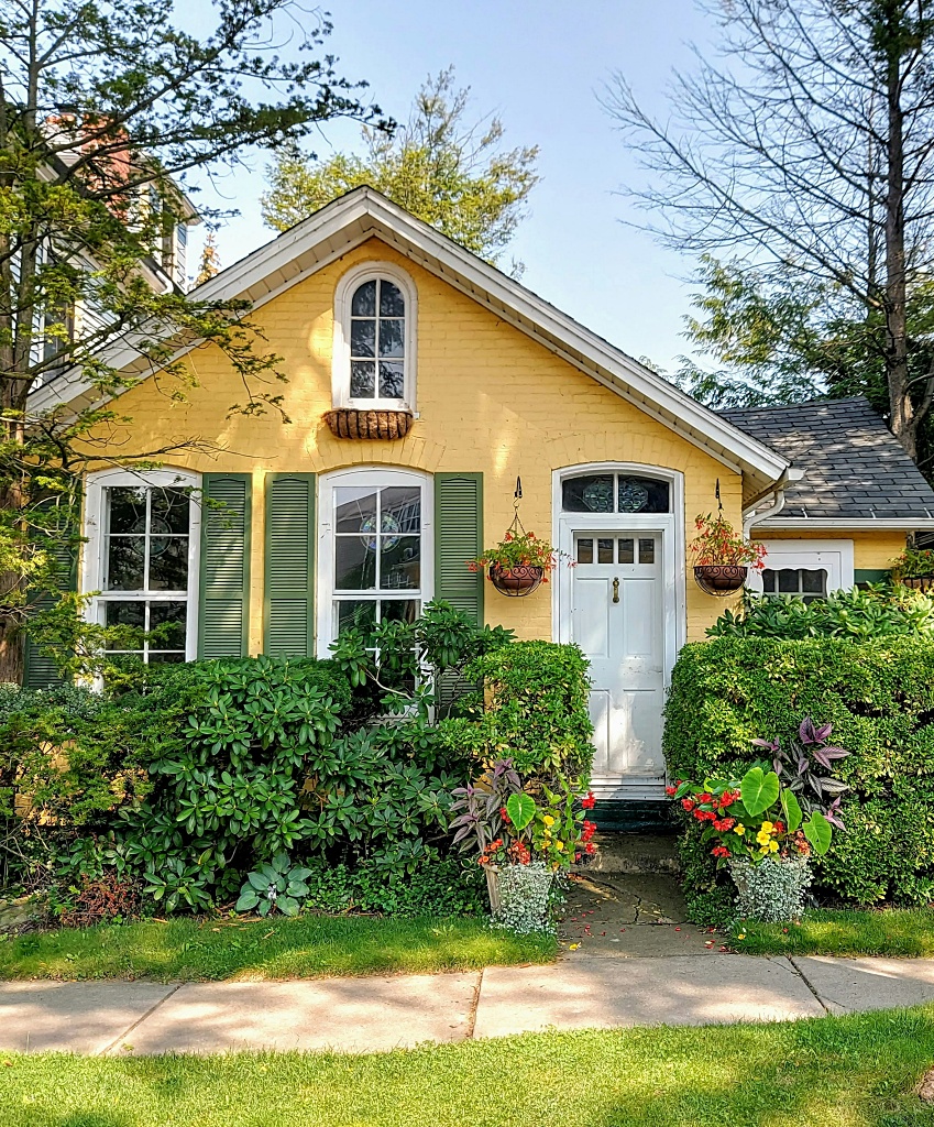 charming little cottage - yellow siding and light green trim