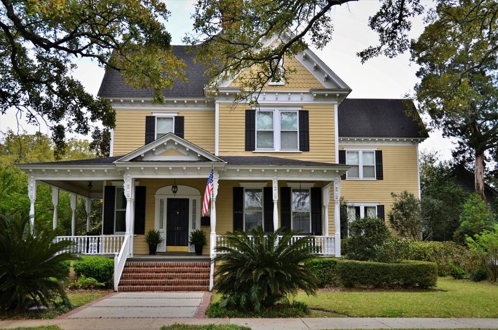 Victorian yellow house with full front porch