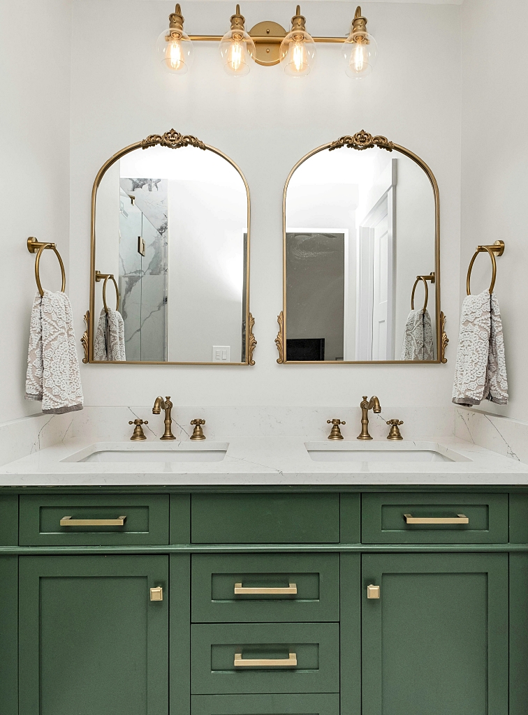 dark green bathroom vanity with gold accents