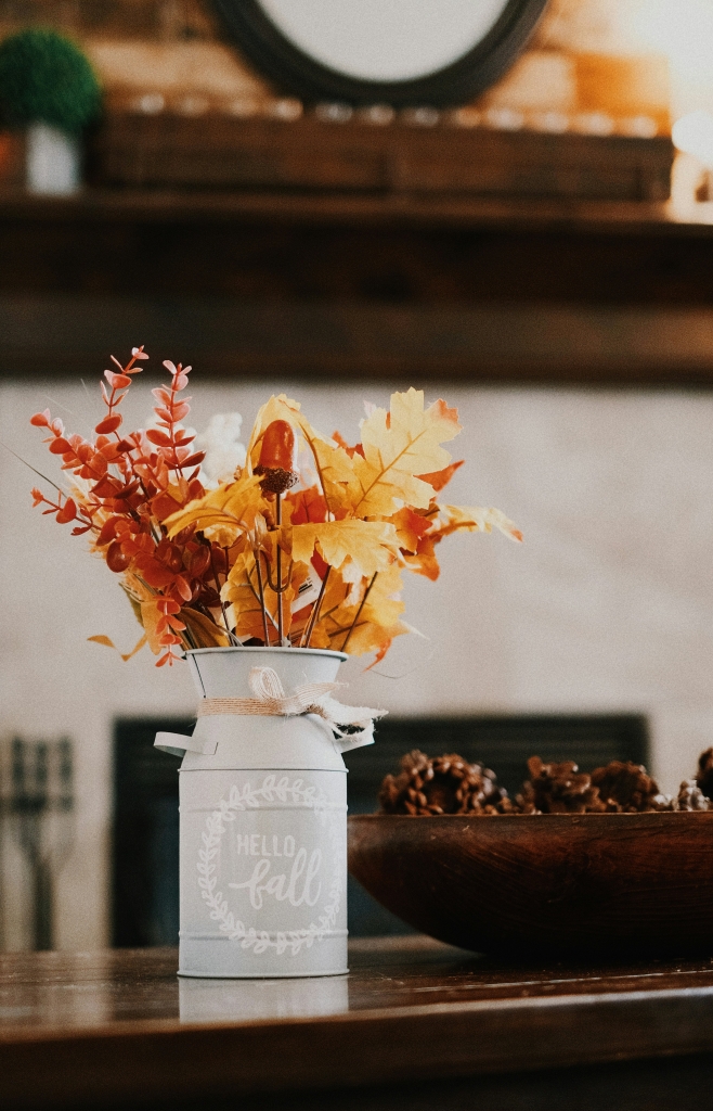 small tin can with fall branches