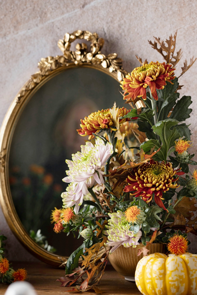 vintage mirror with fall flower arrangement