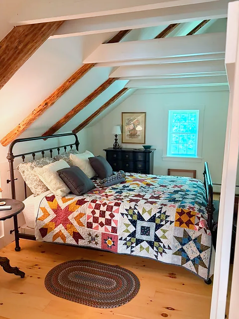 1800s Vermont farmhouse bedroom with iron bed